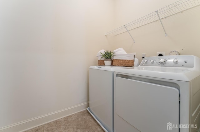 7209 Minuteman Ln, Franklin, NJ 08873 - laundry area with washing machine and clothes dryer, baseboards, and light tile patterned floors