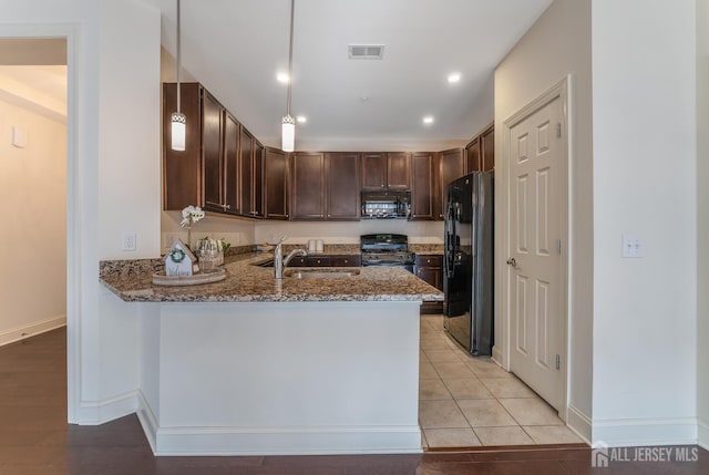 7209 Minuteman Ln, Franklin, NJ 08873 - kitchen featuring black appliances, a sink, stone counters, a peninsula, and dark brown cabinetry