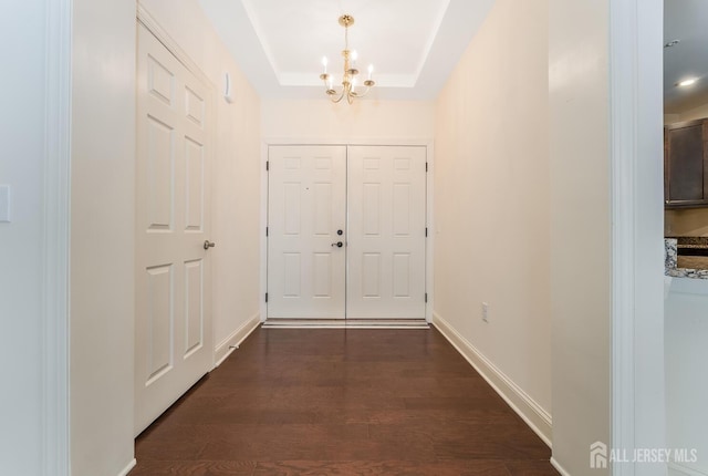 7209 Minuteman Ln, Franklin, NJ 08873 - entrance foyer with a chandelier, dark wood-type flooring, baseboards, and a tray ceiling