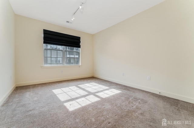 7209 Minuteman Ln, Franklin, NJ 08873 - spare room featuring rail lighting, carpet floors, and baseboards