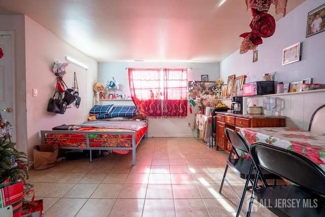 bedroom with light tile patterned floors