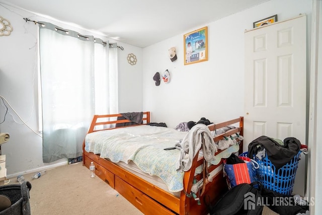 bedroom featuring carpet floors and baseboards