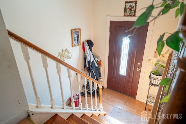 entryway with stairs and wood finished floors