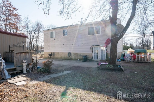 back of property with french doors and a patio area