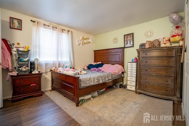 bedroom with wood finished floors