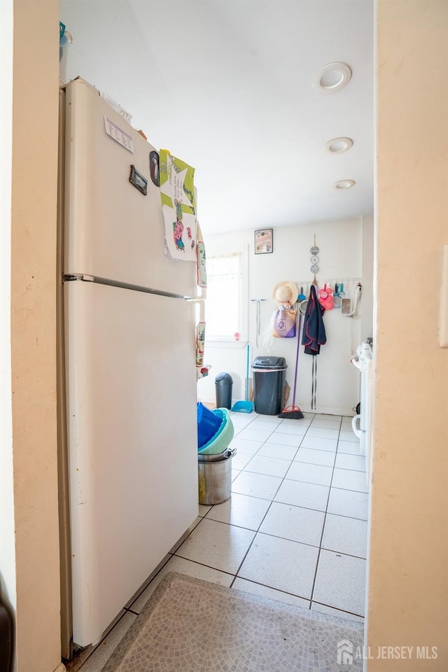 kitchen featuring freestanding refrigerator and tile patterned flooring