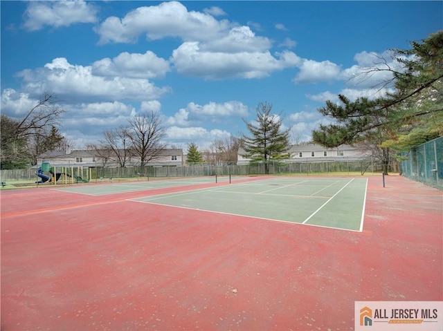 view of tennis court featuring basketball hoop