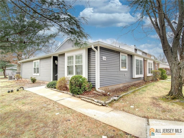 single story home featuring central AC and a front lawn