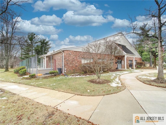 view of side of home featuring a lawn