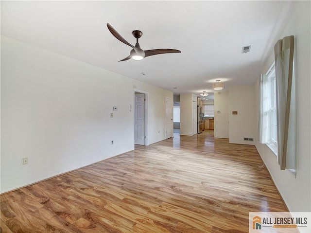 unfurnished living room with light wood-type flooring and ceiling fan