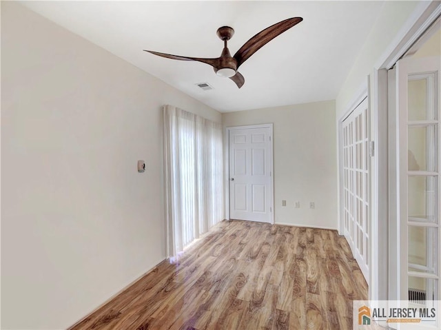 unfurnished room with ceiling fan and light hardwood / wood-style flooring