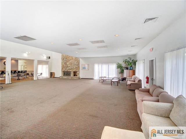 carpeted living room with a baseboard radiator and a fireplace