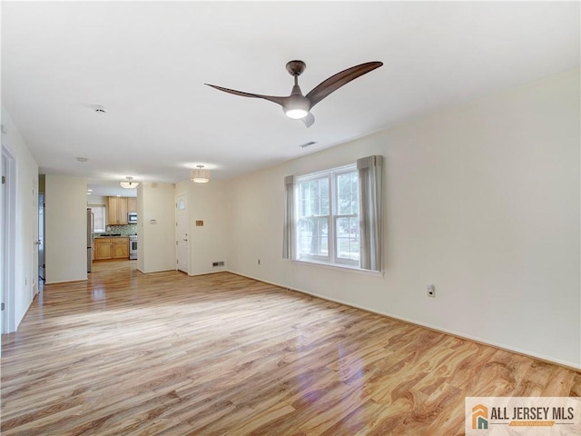 unfurnished living room featuring light hardwood / wood-style floors and ceiling fan