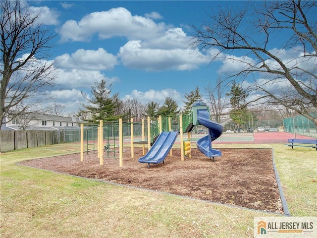 view of play area featuring a yard and tennis court