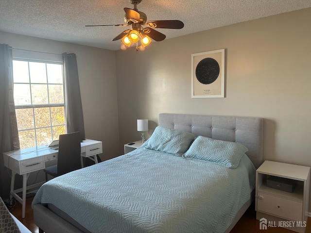 bedroom featuring a textured ceiling and ceiling fan