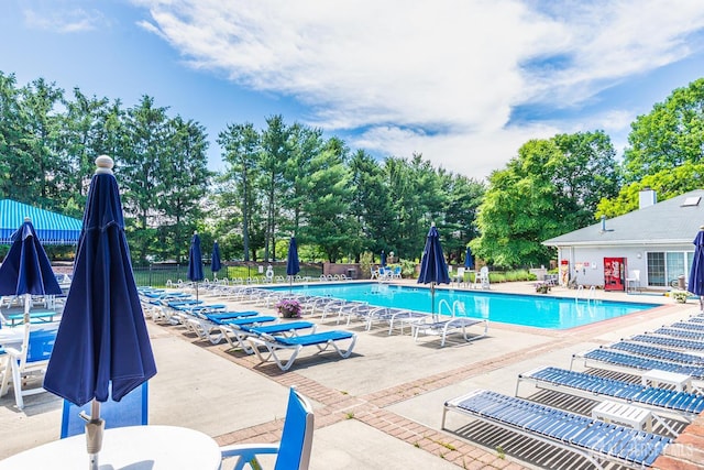 pool with a patio and fence