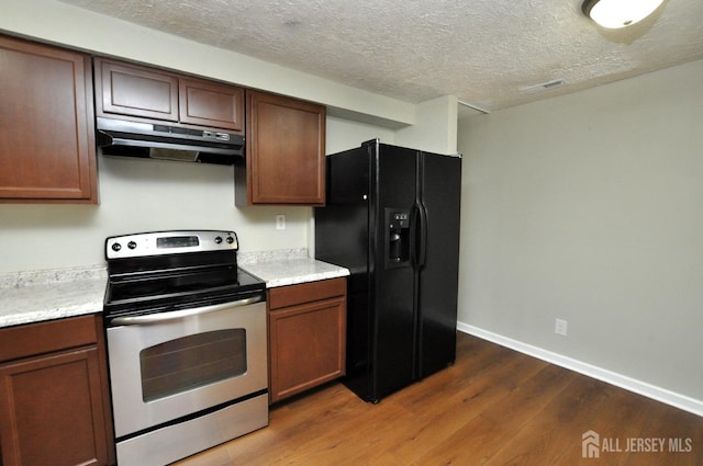 kitchen with black refrigerator with ice dispenser, stainless steel range with electric cooktop, a textured ceiling, wood finished floors, and under cabinet range hood