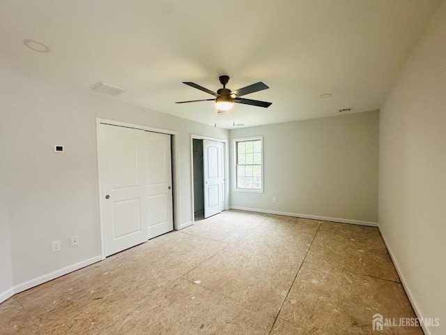 unfurnished bedroom featuring multiple closets, baseboards, and ceiling fan