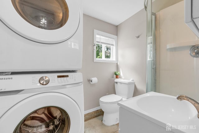 4 Dayton Rd, Edison, NJ 08817 - bathroom with stacked washer / drying machine, baseboards, a sink, toilet, and a shower