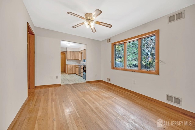 unfurnished living room featuring visible vents and light wood finished floors