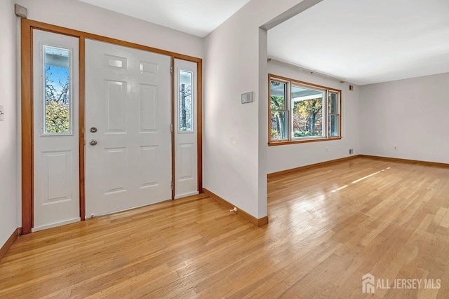 entryway with light wood-style floors and baseboards