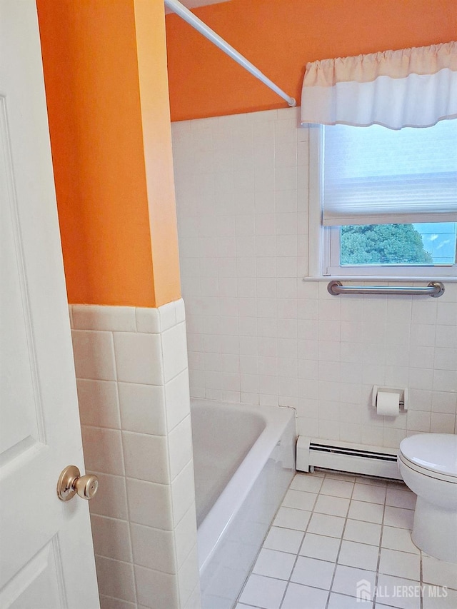 bathroom featuring tile patterned flooring, toilet, shower with separate bathtub, baseboard heating, and tile walls