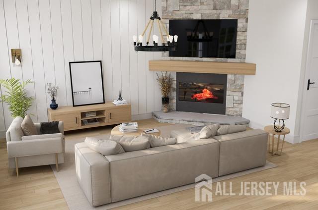 living room featuring a fireplace, light hardwood / wood-style flooring, and a notable chandelier