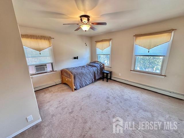 bedroom featuring a baseboard heating unit, cooling unit, carpet floors, baseboard heating, and ceiling fan