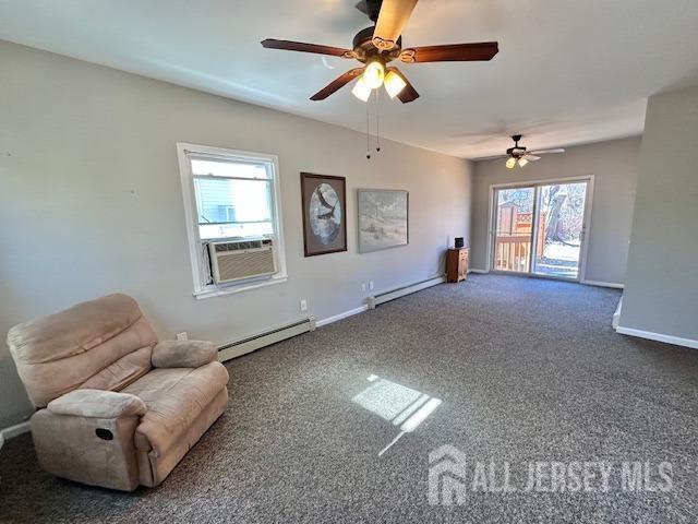 unfurnished room featuring a baseboard heating unit, ceiling fan, baseboards, and carpet
