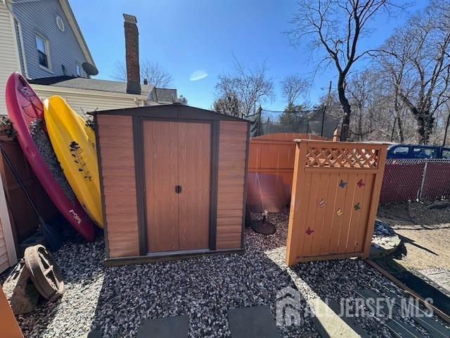 view of shed with fence