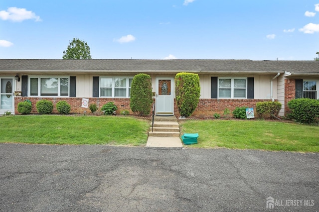 10 Nebraska Dr, Old Bridge, NJ 07747 - ranch-style home with brick siding, a front yard, and a shingled roof