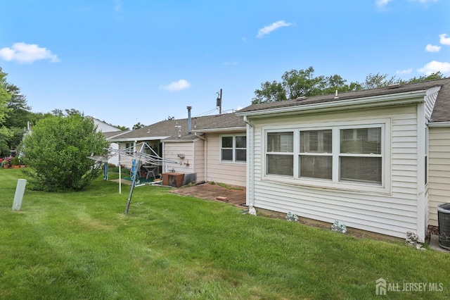 10 Nebraska Dr, Old Bridge, NJ 07747 - back of property featuring a lawn and central AC