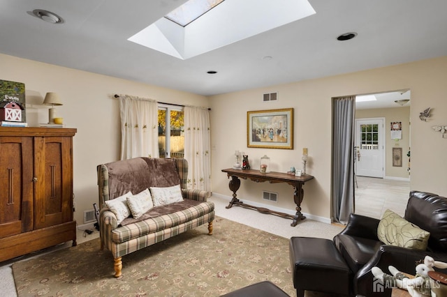 carpeted living room with a skylight