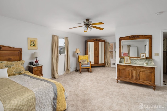 bedroom with ceiling fan and light colored carpet