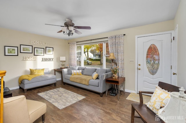 living room with ceiling fan and dark hardwood / wood-style flooring