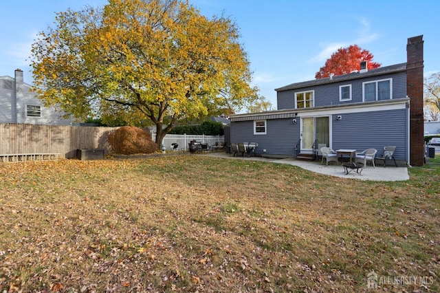 back of house with a yard and a patio area