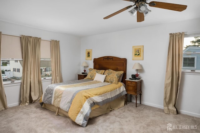 bedroom featuring ceiling fan and light colored carpet