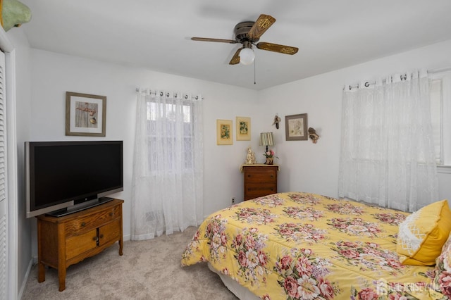 bedroom with light colored carpet and ceiling fan