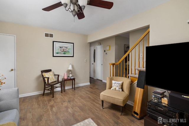 living area with hardwood / wood-style flooring and ceiling fan