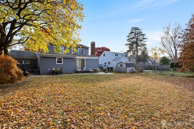 rear view of house with a patio area and a yard