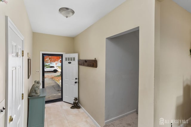 doorway with light tile patterned floors