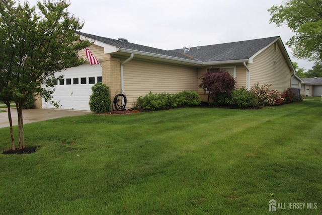 816-C Deal Rd, Monroe, NJ 08831 - view of side of property with driveway, a garage, a lawn, brick siding, and a shingled roof