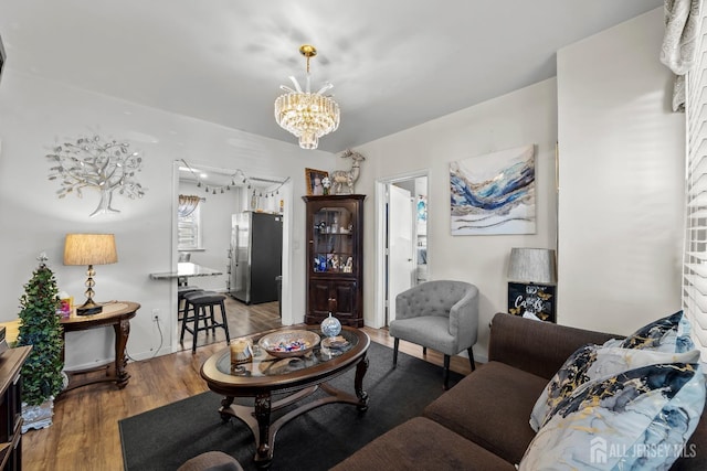 living area with an inviting chandelier and wood finished floors