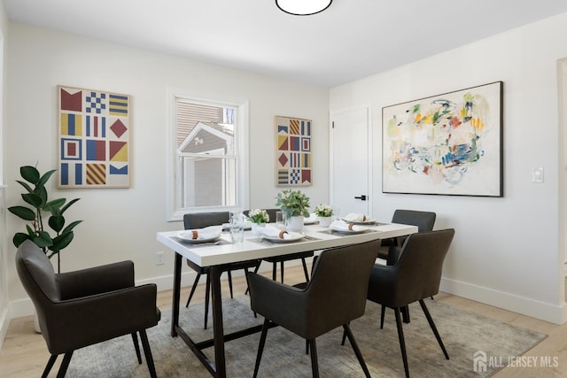 dining area with light wood-type flooring