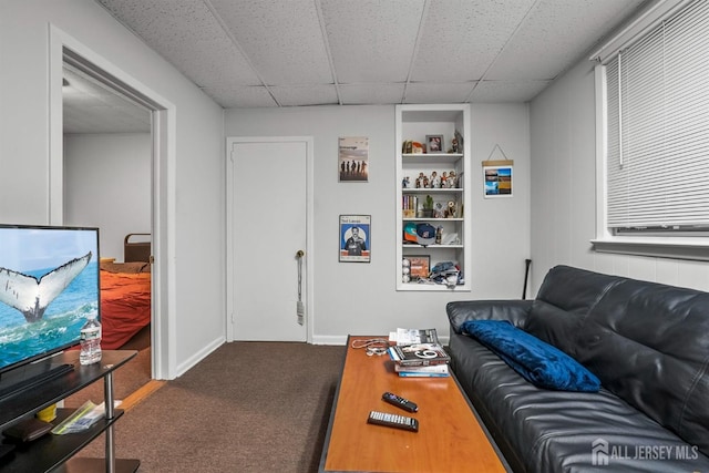 311 Magnolia St, Highland Park, NJ 08904 - carpeted living area with a paneled ceiling, built in features, and baseboards