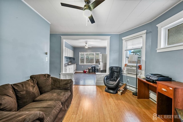 311 Magnolia St, Highland Park, NJ 08904 - living area featuring cooling unit, ornamental molding, a ceiling fan, baseboard heating, and wood-type flooring