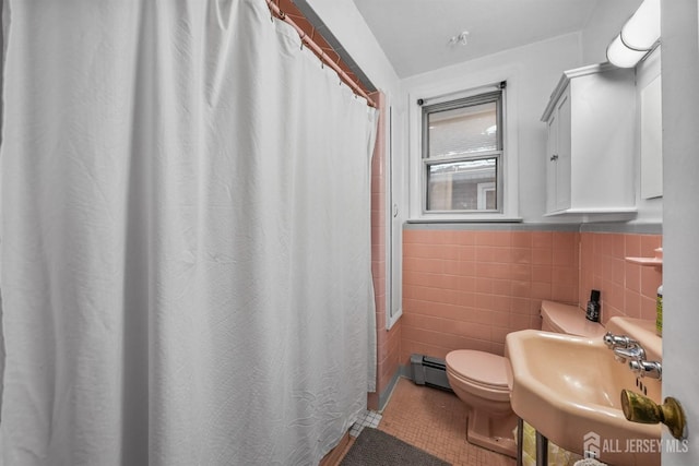 311 Magnolia St, Highland Park, NJ 08904 - full bathroom with a sink, tile walls, toilet, baseboard heating, and tile patterned flooring