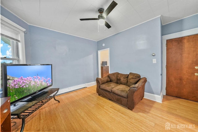 311 Magnolia St, Highland Park, NJ 08904 - living area featuring a baseboard radiator, wood finished floors, ceiling fan, and baseboards