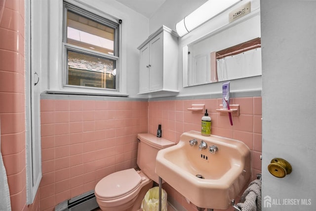 311 Magnolia St, Highland Park, NJ 08904 - full bath with toilet, a sink, a baseboard radiator, a wainscoted wall, and tile walls