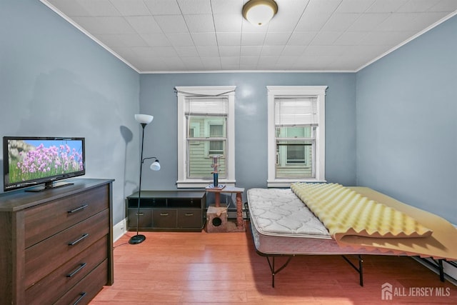 311 Magnolia St, Highland Park, NJ 08904 - bedroom with light wood-type flooring, baseboards, ornamental molding, and a baseboard radiator